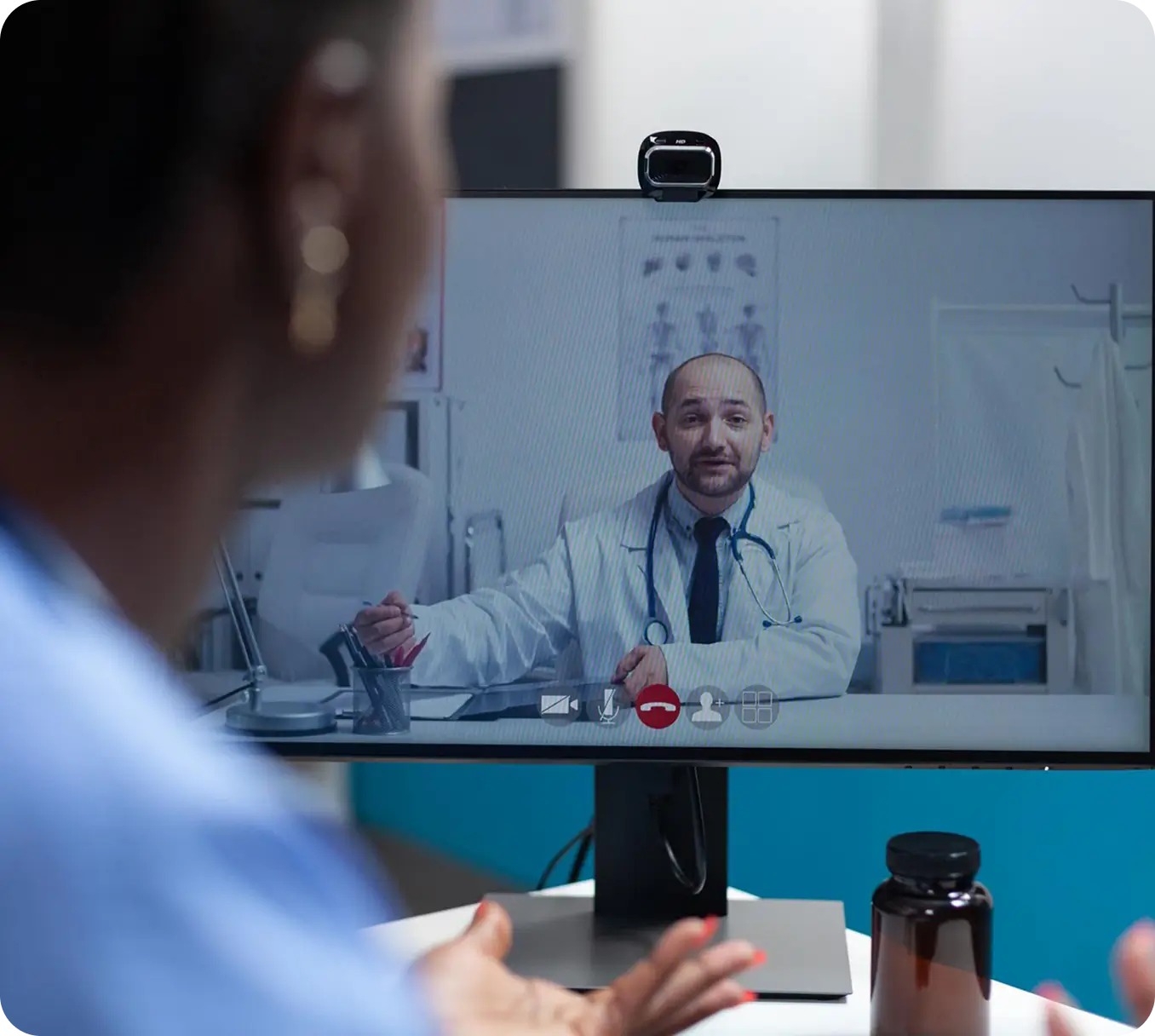 Doctor seen on screen delivering a webinar whilst student in foreground watching