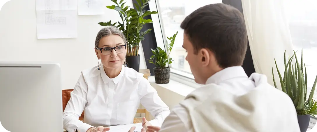 Hands placed on laptop, online meeting with 4 individuals on screen